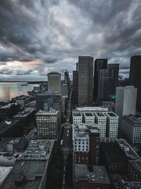 High angle view of buildings in city against cloudy sky