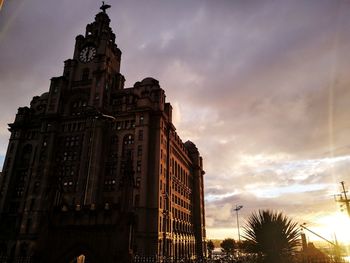 Low angle view of buildings against sky during sunset