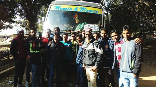 Group of people standing by the road in city