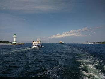 Boats sailing in sea against sky