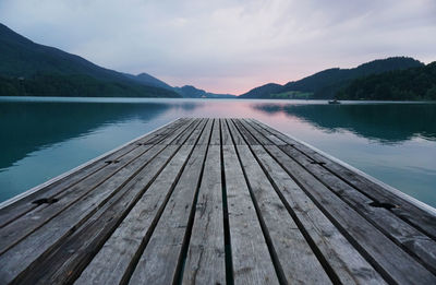 Pier over lake against sky