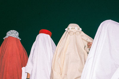 Low angle view of clothes hanging against white wall