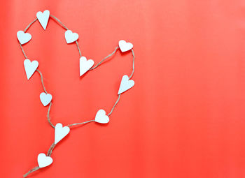 Close-up of heart shape on red wall