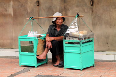 View of a man selling snack on the side  walk.