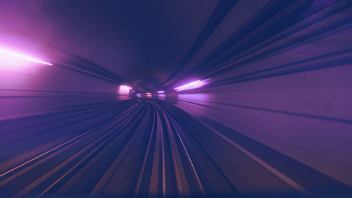 Low angle view of illuminated tunnel