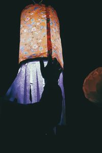 People standing against black background