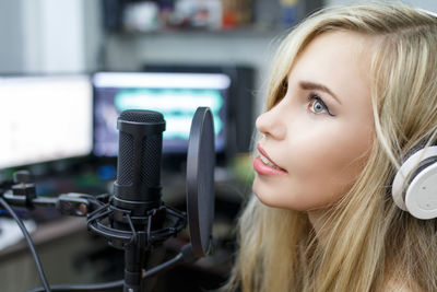 Woman preparing to sing in recording studio