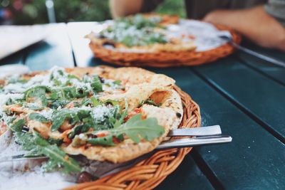 Close-up of pizzas served on table