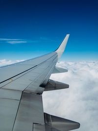 Close-up of airplane wing against sky