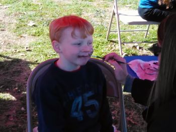 Portrait of girl sitting on grassy field