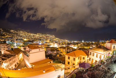 High angle view of illuminated buildings in city at night