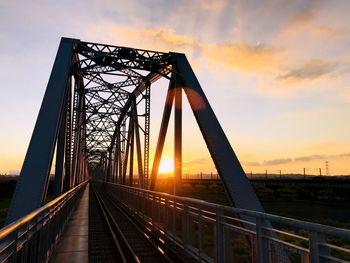 Low angle view of bridge against sky during sunset