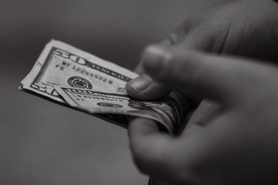 Cropped hand holding paper currency