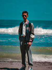 Full length of young man standing at beach