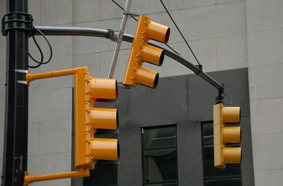 Low angle view of yellow signal on building