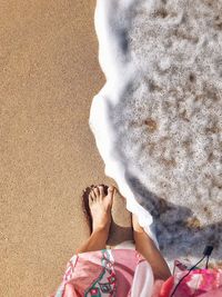 Low section of couple standing on beach