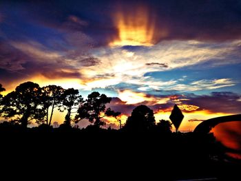 Low angle view of silhouette trees against sky during sunset