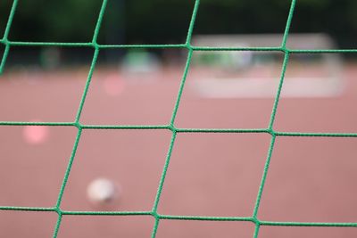 Close-up of soccer goal net on field