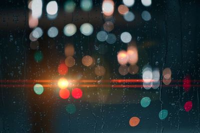 Drops on the window with street lights background at night