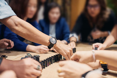 Midsection of people on table