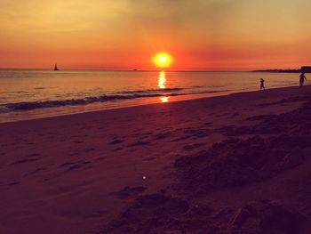 Scenic view of beach against sky during sunset