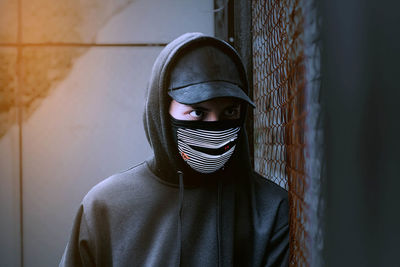 Close-up of man wearing mask and cap