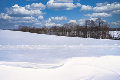 Scenic view of snow covered landscape against sky