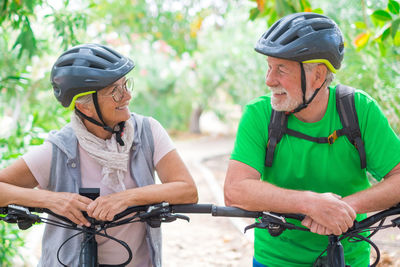 Friends riding bicycles on field