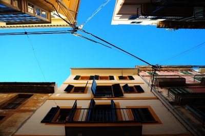 Low angle view of buildings against blue sky