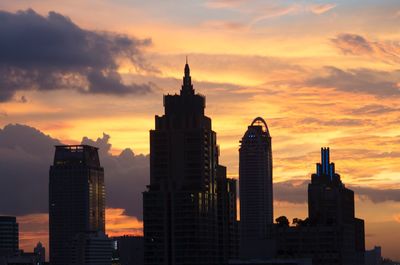 Modern buildings in city during sunset