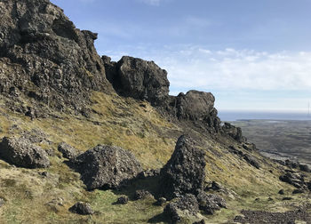 Rock formations in sea against sky