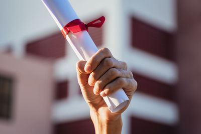 Close-up of hand holding red wine