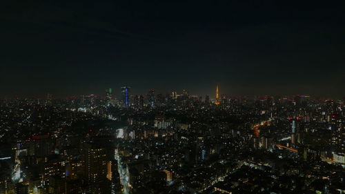 High angle view of illuminated buildings against sky at night