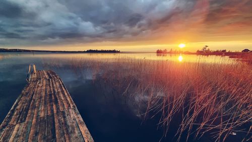 Panoramic view of lake against sky during sunset