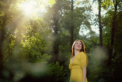 Woman standing in forest