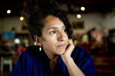 Mixed race woman looking away at morning.