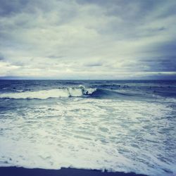 Scenic view of sea against cloudy sky