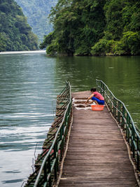 Man sitting on boat in river