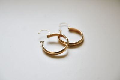 Close-up of wedding rings on table against white background