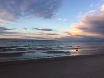 Scenic view of beach against sky during sunset