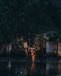 Reflection of trees in lake at night