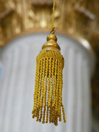 Close-up of yellow decoration hanging on tree