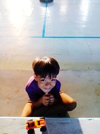 Portrait of cute boy sitting in swimming pool