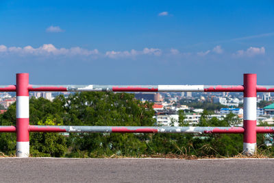 Red metal railing against blue sky