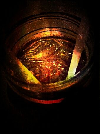 close-up, indoors, glass - material, single object, studio shot, still life, reflection, no people, transparent, burning, black background, old, selective focus, drinking glass, flame, circle, drink, glowing, dark, detail