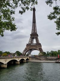 View of bridge over river against cloudy sky