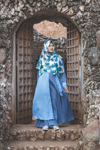 Woman in traditional clothing standing on doorway