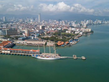 Aerial view of sea and buildings against sky