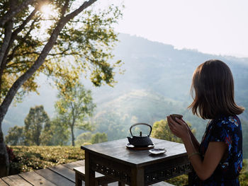 Woman drinking tea in garden