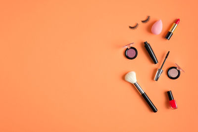 High angle view of lamp on table against orange background